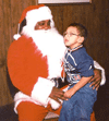 Blind child sitting in Santa's lap
