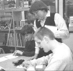 Photo of John Miller and Arthur Given reading Braille.