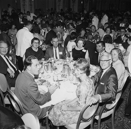 Federation leaders and congressional guests seated at a banquet table in the ballroom. Those seated with their backs to the camera are turned to look at the photographer.