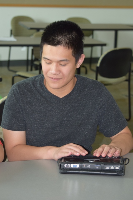 A student uses a Braille display.