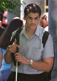 Ahmed Salem uses his cane to cross the school campus.