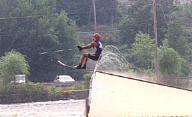 Alllen Golabek om water skis takes off for a jump
