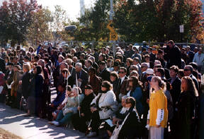 The crowd listens to the speakers.