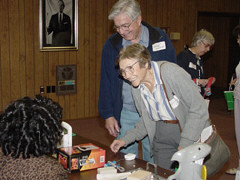Thomas and Esther Clement smile together as they examine a Bagel Biter.