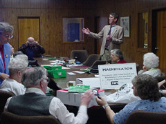 Jim Deremeik of the Wilmer Eye Institute discusses magnification devices with a table-ful of interested seniors.