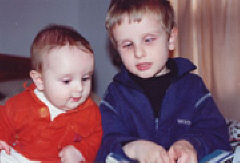 Sami Osborne reads a book to his little brother Luca.