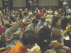 Members of the audience examine the replicas of Whozit passed out to everyone present.  Later people discovered that clapping with Whozit in one hand made a very interesting sound.