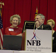 Harold Snider presents the Louis Braille Award to Pamela Lorimer.