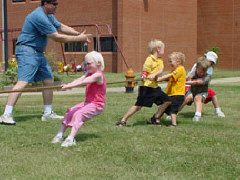 Kids enjoy the old game of tug of war.