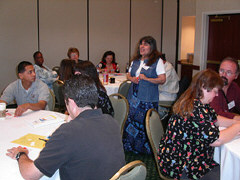 Eager parents listen carefully as Caroline Rounds teaches them about Braille.