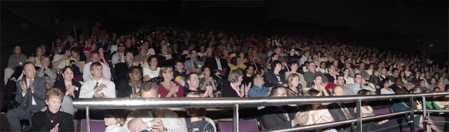 Panoramic view of the crowd seated in the IMAX theater.