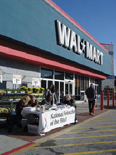 Affiliate members across the country set up NFB Meet-the Blind-Month information tables at local Wal-Mart stores.   Pictured here, NFB of Maryland members prepare to meet and greet the public.