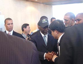 WBU officials presented President Mbeki with the bag, jacket, and cap worn byWBU volunteers.   He immediately put on the hat and wore it as he greeted delegates on his way out.