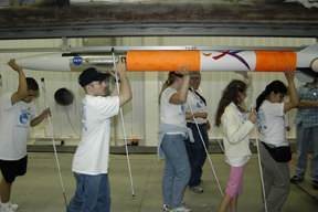 Blind students carrying rocket