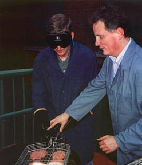 Steve Marriott and Marc Maurer grilling hamburgers.