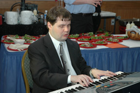 NFB staff member Chris Danielsen provides background music on a keyboard at the celebration.