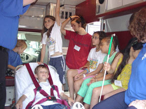 Children explore an ambulance