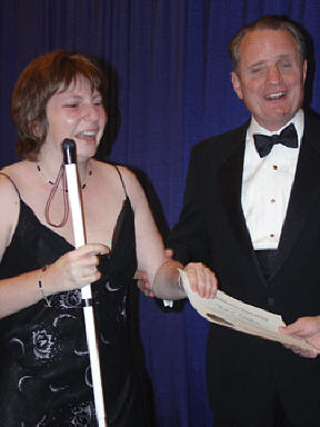 Ronit Ovadia, obviously deeply moved, stands with President Maurer on stage at the banquet.