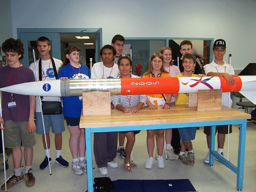 Here all eleven Rocket On! participants: (back row, left to right) Michael Welty, Helen Stevens, and Kelly Wills; (front row) James Dietz, Kyle Conley, Nicole Torcolini, Beto Carreto, Keao Wright, Heather Hammond, Jonathon Nolan, and Nijat Worley pose with the completed rocket somewhat before launch.