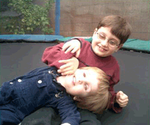 Vejas and Petras Vasiliauskas wrestle on their trampoline.