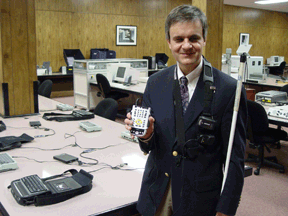 Steven Booth, IBTC access technology specialist, holds the Trekker Bluetooth, Version 2.7