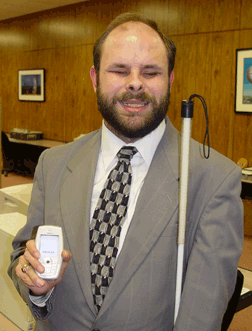 Mike Tindell displays the Nokia 6620 phone loaded with the Talks software.