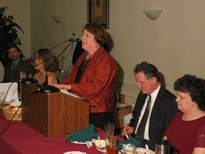 Joanne Wilson addresses the NFB of Louisiana banquet. Listening are Pam Allen (left) and Marc and Patricia Maurer.