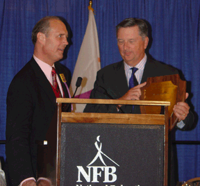 James Gashel addresses the banquet while John Lumpkin displays a plaque.
