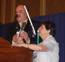Kevan Worley prepares to present Dolores Reisinger with the Imaginator of the Year Award.