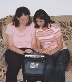 Randa (right) teaches Rebekah Arabic Braille using Rebekah�s BrailleNote.