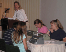 The members of the kids� team listen intently while Kristin Chandler of MATHCOUNTS gives instructions.