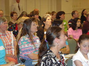 An attentive crowd looks on, Osterhaus describes math techniques, tools, tips, strategies, and resources for blind youth.