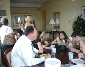 A crowd of young people enjoy lunch in the Affiliate Action suite during the scholarship alumni mentoring program meeting.