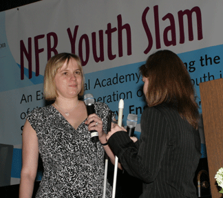 Stacy Cervenka and Chelsea Mu&ntilde;oz conduct a mock interview for the Youth Slam on stage.