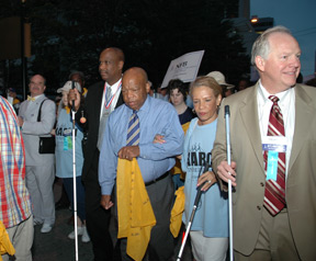Congressman John Lewis walks with NFB of Georgia President Anil Lewis at the front of the line.