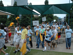 Marchers flow into the park, affiliate banners held high.