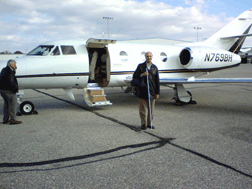 Jim Gashel stands in front of the open door of the air ambulance.