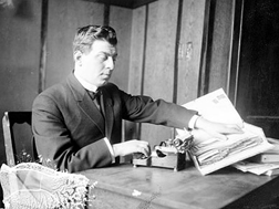 Dr. Jacob Bolotin simultaneously reading Braille and typing. This photograph was published in a 1914 newspaper shortly after Dr. Bolotin graduated from medical school.