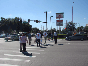 On October 15, White Cane Safety Day, Sherri Brun of Orlando, Florida, helped organize a street-crossing event, in which County Commissioners Fernandez and Stewart (under sleepshades) were safely escorted across a busy intersection, learning firsthand the importance of orientation skills.