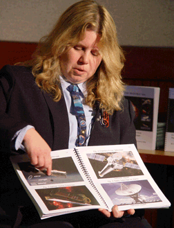 Noreen Grice displays two pages of tactile photos in the book she authored with Simon Steel and Doris Daou, both affiliated with NASA.