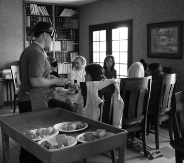 Sean Whalen�s guests were delighted to accept an invitation to lunch. After sniffing the aroma of the dishes he was preparing, they were even happier to find that the meal was right on time. Here Sean delivers the plates of food to his guests from a serving cart.