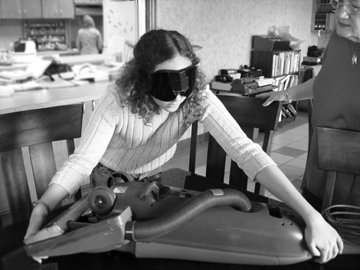 Arielle Silverman learns to install the belt in an upright vacuum cleaner.