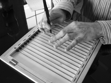 A student works on writing a legible signature.