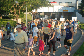 A crowd of Federationists travel under an overpass in route to Victory Plaza.