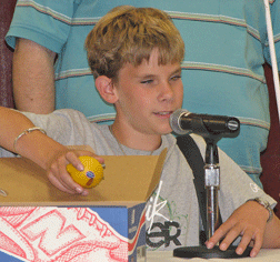 Alex Butler (Kansas) explains his fruit battery at the press conference.
