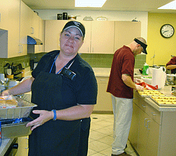 Julee Mullen works with a Business Enterprise student in the kitchen.