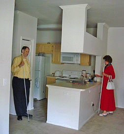 Dan Frye and Barbara Pierce examine a kitchen of a student apartment.