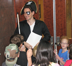 Captain Whozit greets the students in the atrium and explains the scavenger hunt.