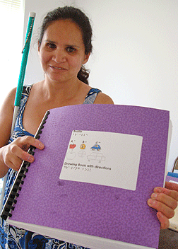 Michelle Chacon displays the tactile book made by Trina Boyd-Pratt. These books are available for sale.