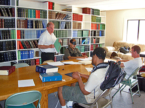 Tom Anderson works with four students.